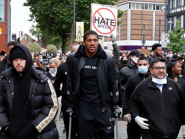 Anthony Joshua takes part in Black Lives Matter march on crutches
