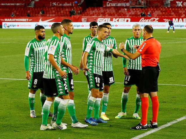 Real Betis players complain to the referee during their match against Sevilla on June 11, 2020
