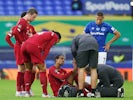 Liverpool defender Joel Matip receives medical attention during the derby against Everton on June 21, 2020