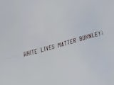 A banner reading 'White Lives Matter Burnley' flies over the Etihad on June 22, 2020