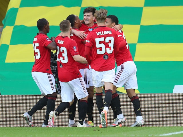 Manchester United defender Harry Maguire celebrates with teammates after scoring the winner against Norwich on June 27, 2020