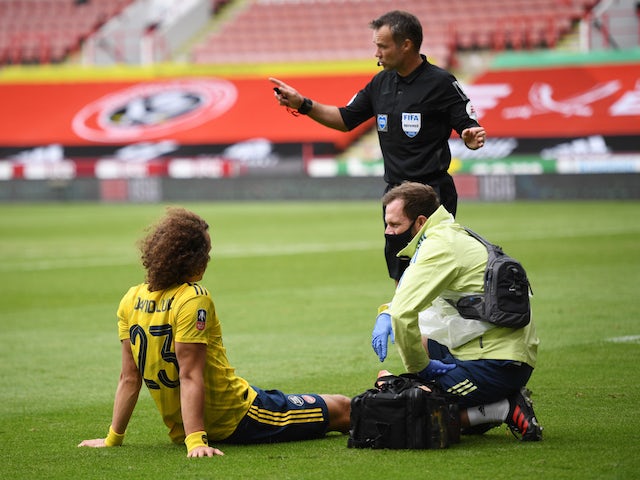 Arsenal defender David Luiz receives treatment for an injury on June 28, 2020