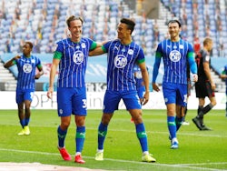 Wigan Athletic players celebrate after a Stoke City own goal on June 30, 2020
