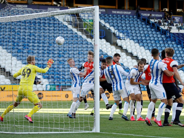 Luton Town's Sonny Bradley scores against Huddersfield Town in the Championship on July 10, 2020