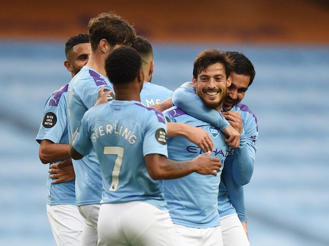 Manchester City midfielder David Silva celebrates with teammates after scoring against Newcastle on July 8, 2020