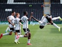 Fulham's Neeskens Kebano celebrates with teammates after scoring against Sheffield Wednesday on July 18, 2020