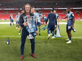 Wycombe Wanderers manager Gareth Ainsworth celebrates with the League One playoff trophy on July 13, 2020