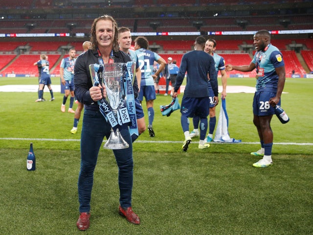Wycombe Wanderers manager Gareth Ainsworth celebrates with the League One playoff trophy on July 13, 2020