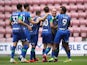 Wigan Athletic players celebrate their opening goal of the 8-0 hammering of Hull on July 14, 2020