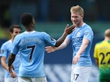 Manchester City's Kevin De Bruyne and Raheem Sterling celebrate against Norwich City in the Premier League on July 26, 2020