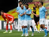 Manchester City's Raheem Sterling celebrates with teammates after scoring against Watford on July 21, 2020