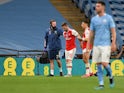 Arsenal defender Shkodran Mustafi is helped off the pitch against Manchester City in their FA Cup semi-final on July 18.