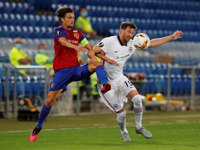 Basel's Valentin Stocker in action with Eintracht Frankfurt's David Abraham in the Europa League on August 6, 2020