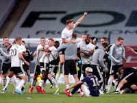Fulham players and staff celebrate in the Championship playoff final on August 4, 2020