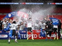 Fulham players celebrate winning promotion to the Premier League on August 4, 2020