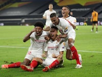 Sevilla players celebrate Lucas Ocampos's goal against Wolverhampton Wanderers on August 11, 2020