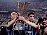 Inter Milan players Dennis Bergkamp and Wim Jonk celebrate with the UEFA Cup in 1994