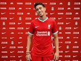 Kostas Tsimikas poses in a Liverpool kit in August 2020