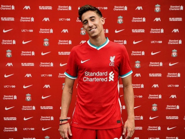 Kostas Tsimikas poses in a Liverpool kit in August 2020