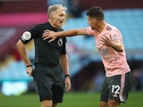 Sheffield United's John Egan protests to referee Graham Scott after being sent off against Aston Villa in September 2020