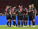 Liverpool players celebrate after Ajax's Nicolas Tagliafico scores an own goal in the Champions League on October 21, 2020