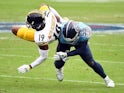 Pittsburgh Steelers' JuJu Smith-Schuster is tackled by Tennessee Titans' Jayon Brown on October 25, 2020