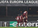 CFR Cluj players celebrate scoring against Young Boys in October 2020