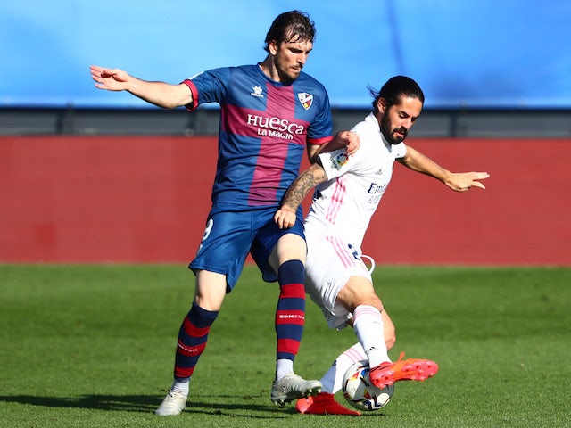 Real Madrid's Isco in action with Huesca's Eugeni in La Liga on October 31, 2020