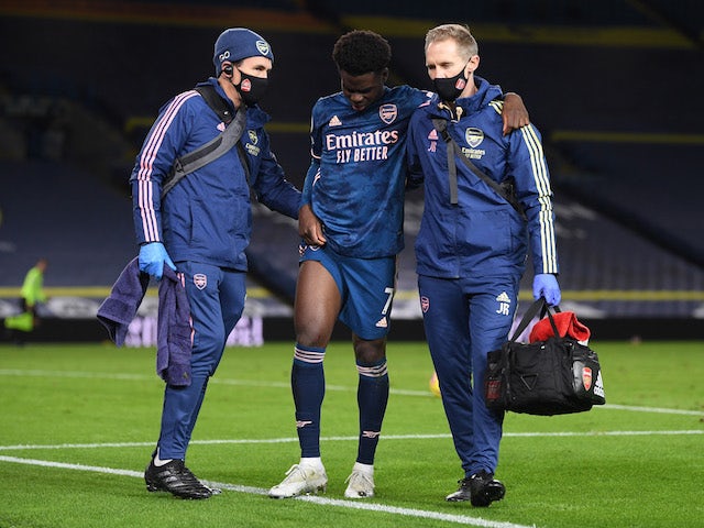 Arsenal's Bukayo Saka is helped off after sustaining an injury on November 22, 2020