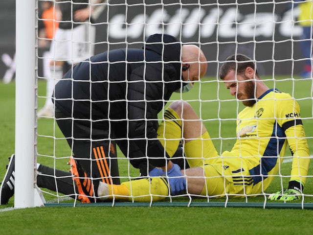 Manchester United goalkeeper David de Gea receives treatment for a knee injury against Southampton on November 29, 2020