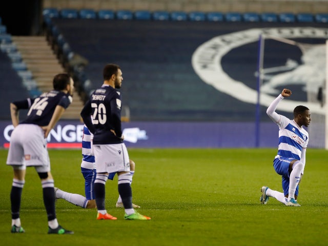 QPR players take a knee while Millwall players stand in the Championship on December 8, 2020