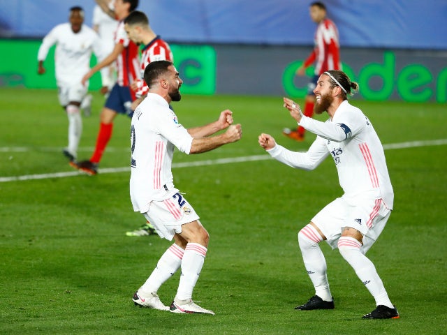 Real Madrid's Dani Carvajal celebrates with Sergio Ramos after Atletico Madrid's Jan Oblak scored an own goal in La Liga on December 12, 2020
