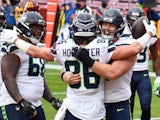 Seattle Seahawks tight end Jacob Hollister is congratulated by guard Ethan Pocic after scoring a touchdown against Washington on December 20, 2020