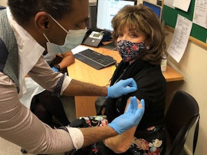 Dame Joan Collins receives coronavirus vaccine