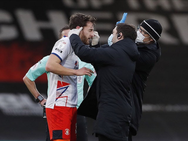Luton Town's Tom Lockyer receives medical attention after clashing with Bournemouth's Jefferson Lerma on January 16, 2021