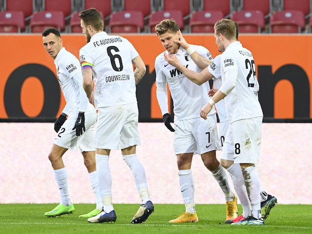 FC Augsburg's Florian Niederlechner celebrates scoring their second goal with teammates on January 23, 2021