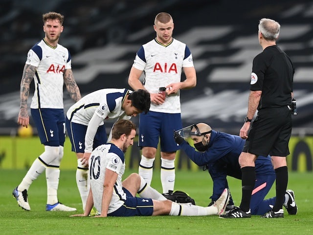 Tottenham Hotspur striker Harry Kane receives treatment for an injury suffered in January 2021