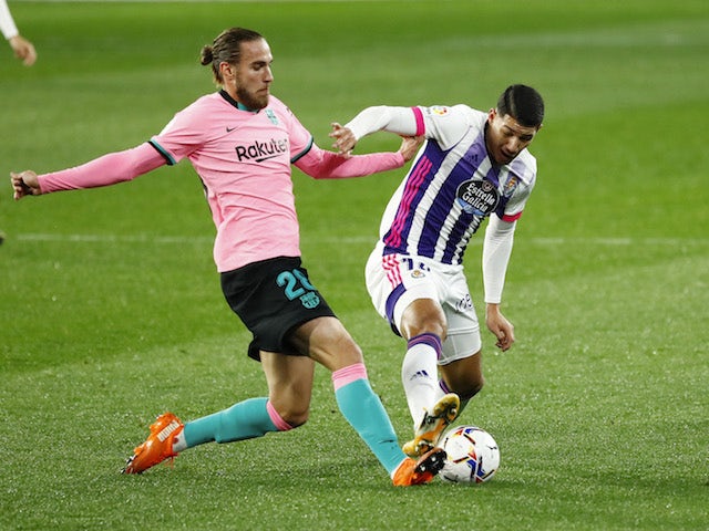Barcelona's Oscar Mingueza in action with Real Valladolid's Marcos de Sousa in La Liga on December 22, 2020