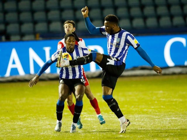 Wycombe Wanderers' Scott Kashket in action with Sheffield Wednesday's Osaze Urhoghide and Cheyenne Dunkley on February 9, 2021