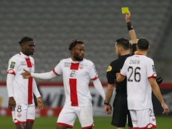 Dijon's Ngonda Muzinga is shown a yellow card by referee Jeremie Pignard in January 2021