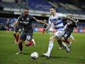 Queens Park Rangers' Lyndon Dykes in action with Brentford's Winston Reid in the Championship on February 17, 2021