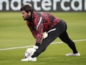 Alisson Becker warms up for Liverpool on February 16, 2021