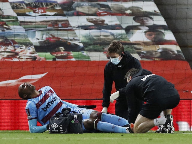 West Ham United's Angelo Ogbonna is treated by medical staff after sustaining an injury in February 2021