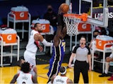 Los Angeles Lakers center Montrezl Harrell dunks the ball against Portland Trail Blazers guard Rodney Hood on February 27, 2021