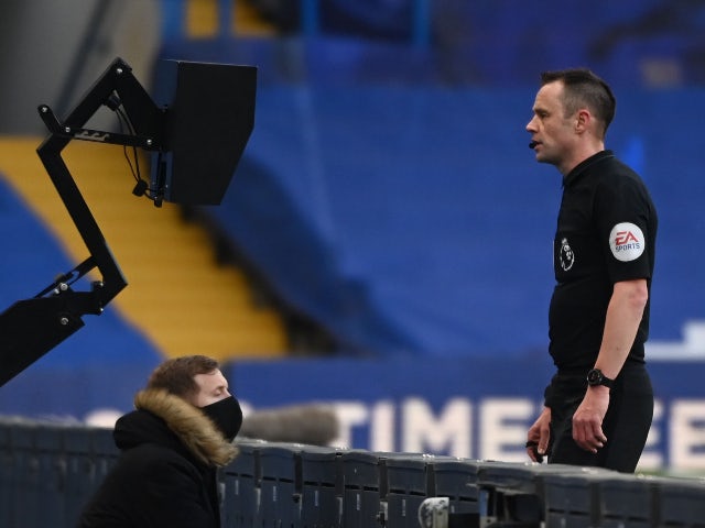 Referee Stuart Attwell looks at the monitor in the Premier League on February 28, 2021