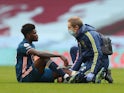 Arsenal midfielder Thomas Partey receives treatment for an injury in February 2021