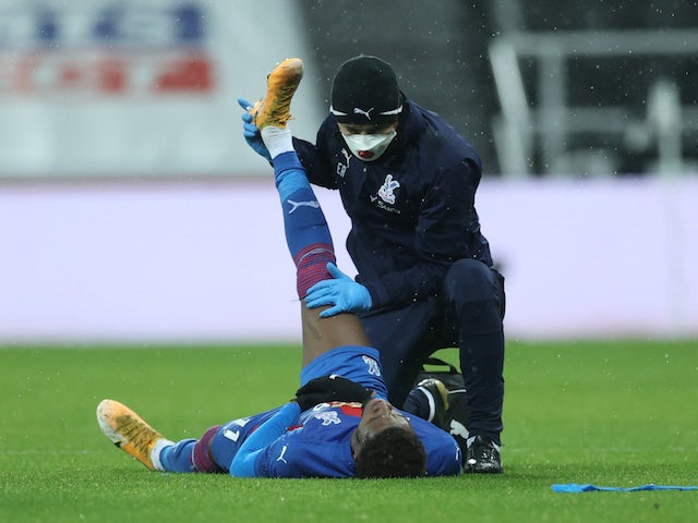 Crystal Palace's Wilfried Zaha receives medical attention after sustaining an injury in February 2021