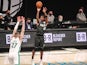 Brooklyn Nets guard Kyrie Irving (11) shoots a three point shot in the third quarter against the Boston Celtics on March 12, 2021