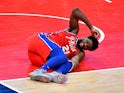  Philadelphia 76ers center Joel Embiid reacts after suffering an apparent leg injury against the Washington Wizards on March 13, 2021