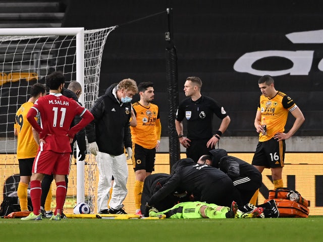 Wolverhampton Wanderers goalkeeper Rui Patricio receives medical attention against Liverpool on March 15, 2021